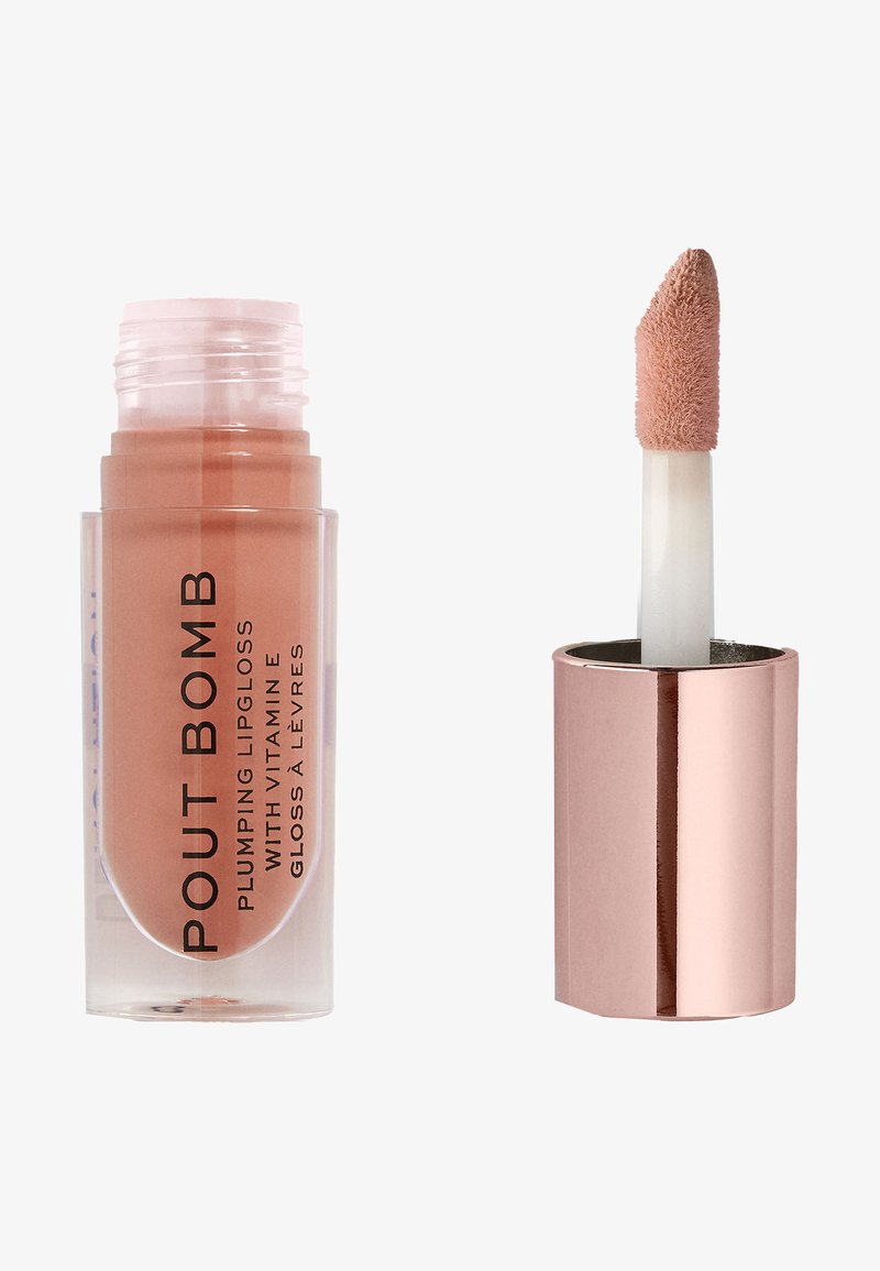 Brillo labial voluminizador en tubo transparente con tono rosa. Incluye un aplicador en forma de pie de ciervo. La etiqueta presenta un texto negro en negrita. Tapa de color plateado/rosa oro.