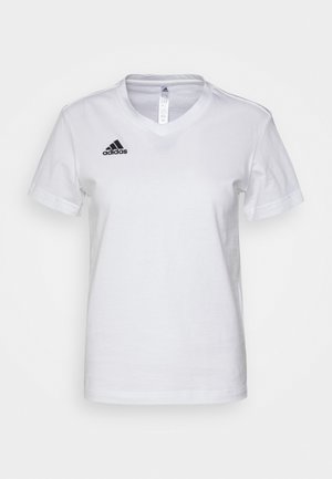 Bijela pamučna majica s V-izrezom, kratkim rukavima i crnim Adidas logom na lijevoj strani prsnog područja. Glatka tekstura, klasičan kroj.
