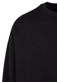 Black sweatshirt featuring a ribbed crew neckline, soft texture, and long sleeves, crafted from a comfortable cotton blend fabric.