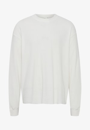 Hvit langermet skjorte med ribbet tekstur, rund hals og subtilt hvitt brodert 'ABC'-logo på brystet. Løs passform med innsvingte mansjetter.