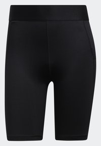 Shorts de sport noirs en tissu extensible. Caractérisés par une taille lisse et un design sans coutures. Longueur jusqu'aux tibias avec une coupe ajustée.