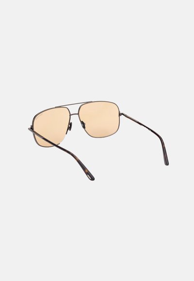 A pair of aviator sunglasses with a thin metallic frame, light brown tinted lenses, and tortoiseshell-patterned temples.