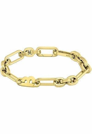 Pulsera de cadena en tono dorado con eslabones ovalados y rectangulares entrelazados, que presenta un distintivo charm con el logo 'B' en uno de los eslabones.