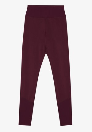 Mallas burdeos con cintura alta, diseño ajustado y acentos de canalé en los tobillos. Fabricadas con tejido elástico para mayor comodidad.