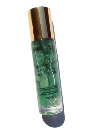Green toner bottle with golden cap, containing aventurine crystals, labeled "Crystal Glow-On," 10 mL size, transparent liquid, smooth texture.