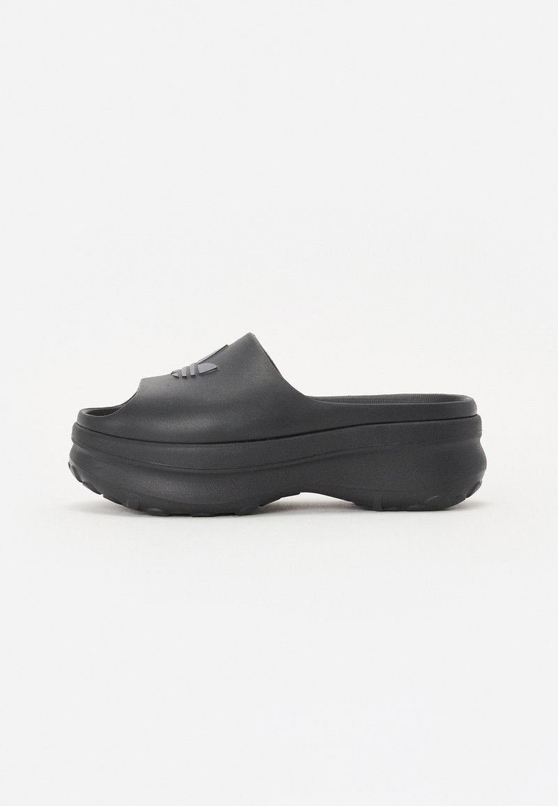 Black molded clogs with a wide opening, rounded toe, and textured sole. Features a subtle logo on the upper part.