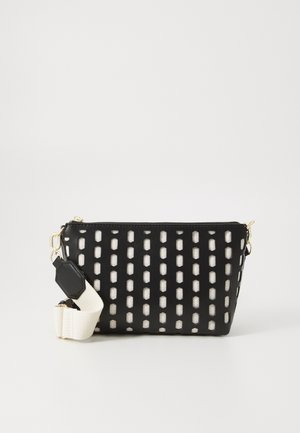 Black handbag with a geometric cutout pattern, featuring a contrasting white interior. Includes a sturdy cream strap and gold hardware accents.