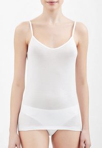 Top in cotone bianco senza maniche con spalline sottili, caratterizzato da una superficie liscia e un design a V, che arriva fino ai fianchi. Semplice e privo di decorazioni.