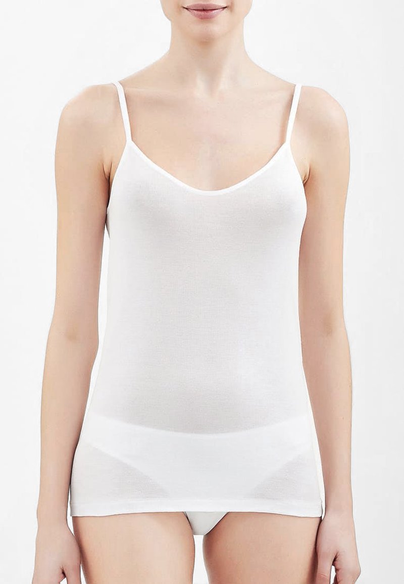 Top in cotone bianco senza maniche con spalline sottili, caratterizzato da una superficie liscia e un design a V, che arriva fino ai fianchi. Semplice e privo di decorazioni.