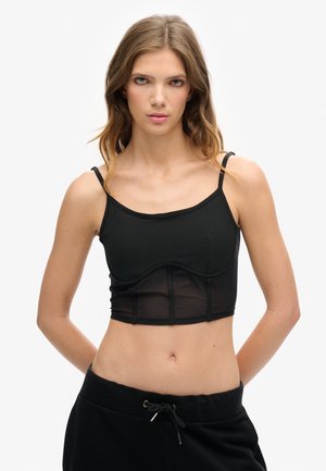 Zwart crop top met verstelbare bandjes, met een aansluitend lijfje met netpanelen en een gestructureerd onderbustontwerp. Glad textuur.