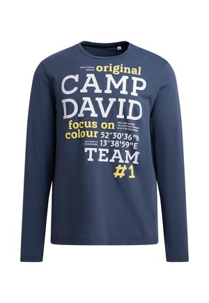 Navy long-sleeve t-shirt made of cotton; features bold white and yellow text "CAMP DAVID" and "#1"; crew neck with a relaxed fit.