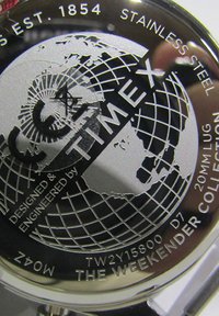 Timex roestvrijstalen horloge achterkant met een wereldkaart graphic, gegraveerde tekst met merknaam, model en ontwerpdetails.