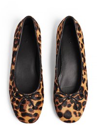 Bailarinas de estampado de leopardo hechas de tela suave, con un acento en forma de lazo negro en la parte delantera y un interior negro suave.