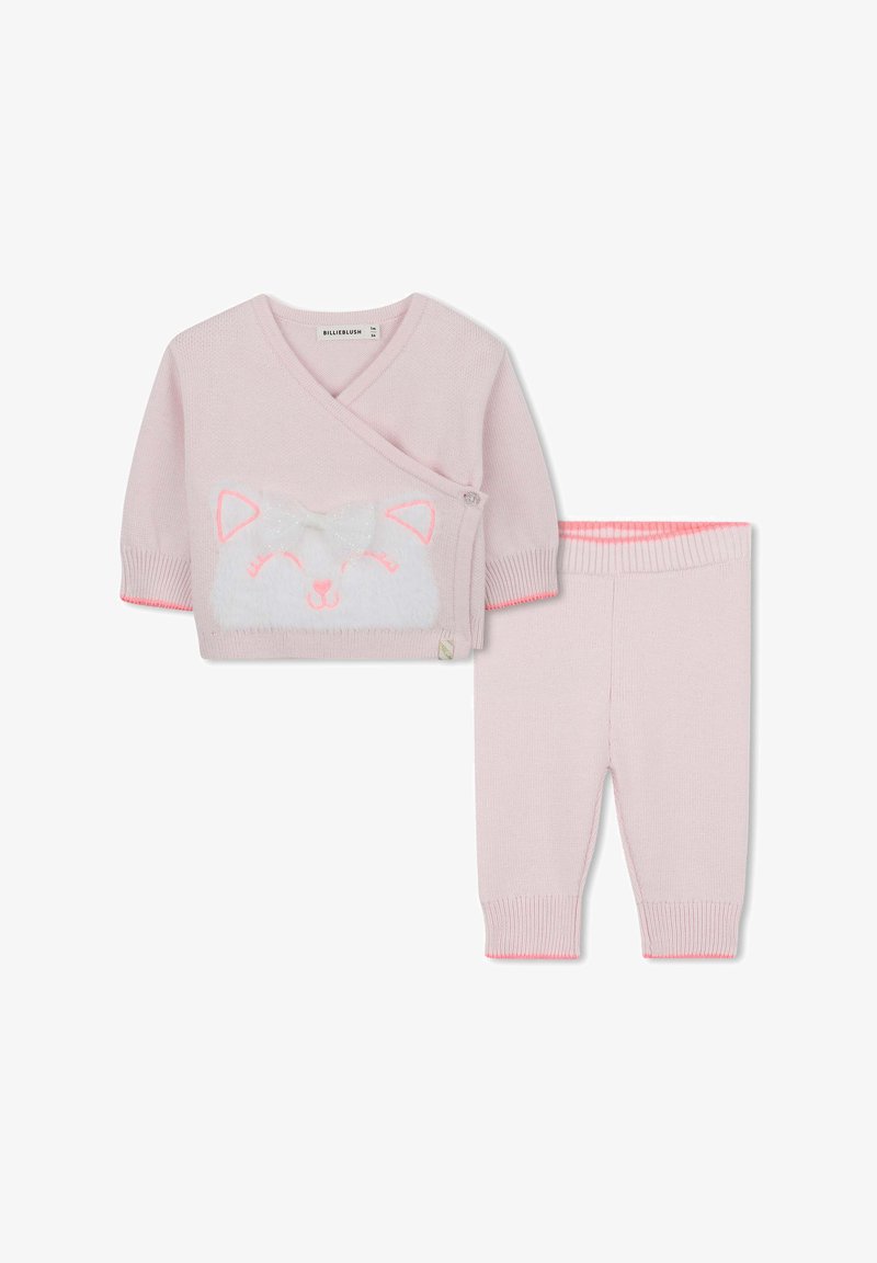 Rózsaszín kötött szett, amely egy fehér róka arccal és masnival díszített felsőből áll, amit párosítanak a megfelelő rózsaszín nadrággal, bordázott mandzsettákkal.