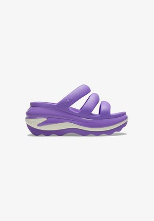 Purple platform sandals with three broad straps. Made of durable material, featuring a thick, textured sole and a white accent band.