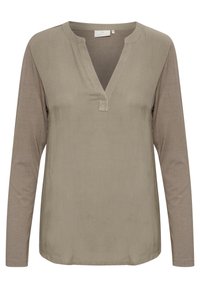 Maglietta a maniche lunghe di un colore taupe tenue, con scollo a V e un piccolo taglio, dettagli in tessuto contrastante sulle maniche. Tessuto morbido.