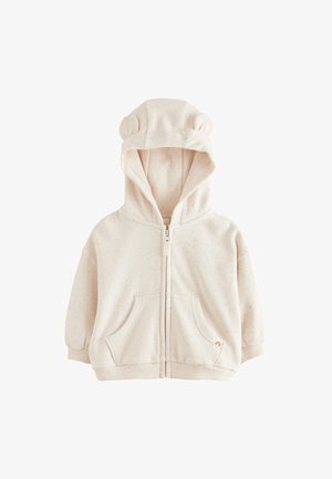 Otroški pulover s kapuco kremne barve z zadrgo, sprednjimi žepi, rebrastimi manšetami in ušesi medveda na kapuci.