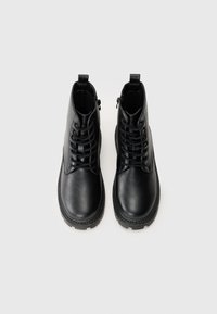 Black leather ankle boots with a round toe, lace-up front, and side zipper. Textured finish with a sturdy rubber sole and minimal stitching.