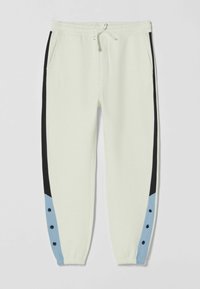 Bílé jogger kalhoty s černými postranními pruhy a modrými akcenty, s černými patentkami poblíž elastických manžet a předních kapes.