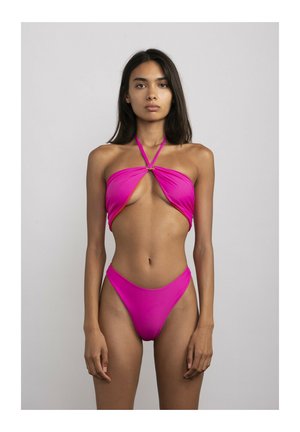 Bright fuchsia bikini featuring a halter neck design, cut-out front with a gold hardware accent, and high-cut legs. Smooth textured fabric.