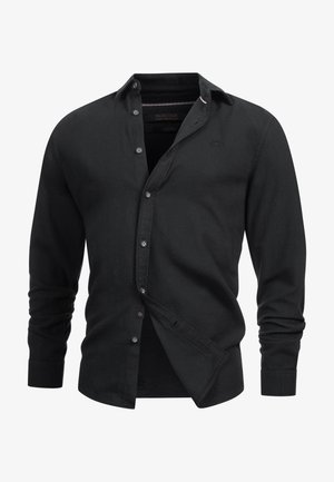 Sort skjorte med lange ærmer, lavet af et glat stof. Den har en klassisk krave og diskret logo detalje på brystet.