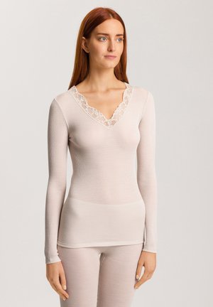 Light pink long-sleeve top with a ribbed texture and lace trim along the v-neckline. Soft fabric, fitted design, and subtle detailing.