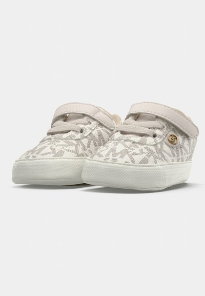 White canvas shoes featuring a geometric pattern, elastic strap, and rubber sole. Soft texture with a subtle sheen and gold accent.