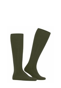 Due calze verdi alte fino al ginocchio con una texture a costine, mostrate in posizione verticale su uno sfondo bianco, enfatizzando il loro colore e i dettagli del design.