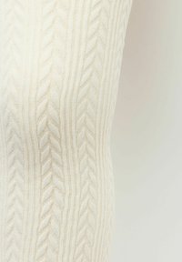 Pletené legíny v barvě off-white s vyvýšenými, texturovanými vzory a hladkým povrchem. Nabízí přiléhavý střih.