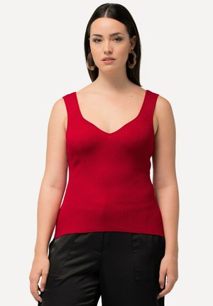 Rode geribbelde tanks top met een V-hals en brede schouderbanden, gemaakt van een aansluitend rekbaar materiaal, gecombineerd met zwarte losse broek.