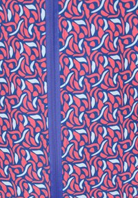 Material textil cu model format din desene ondulate în nuanțe de roșu, alb și albastru, având un fermoar central de culoare mov. Textură netedă, material de greutate medie.