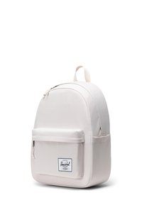 Sac à dos rose clair en tissu durable. Haut courbé, poche zippée à l'avant, écusson logo sur le panneau avant inférieur, et une poignée rembourrée.