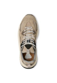 Sneaker in suede beige con lacci bianchi, dettagli neri, linguetta testurizzata e suola intermedia maculata. Presenta una soletta in sughero e dettagli di design unici.