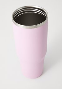 Stainless steel tumbler with a matte pastel pink exterior, tapered shape, and polished metal rim. The interior is dark grey.