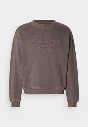 Rudas džemperis su apvalia apačia, ribotu rankogaliu ir apačia. Puošiamas siuvinėtu "TOMMY JEANS" logotipu, minkšta tekstūra. Minimalistinis dizainas.