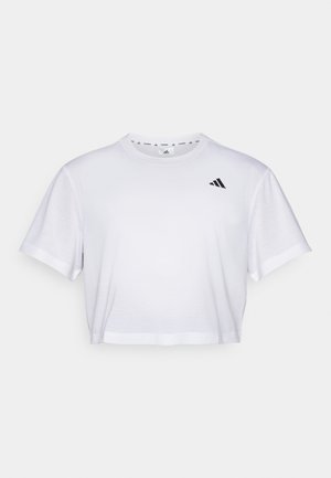 Bílý zkrácený tričko vyrobené z měkké látky, s krátkými rukávy a kulatým výstřihem. Černé logo na levé hrudi.