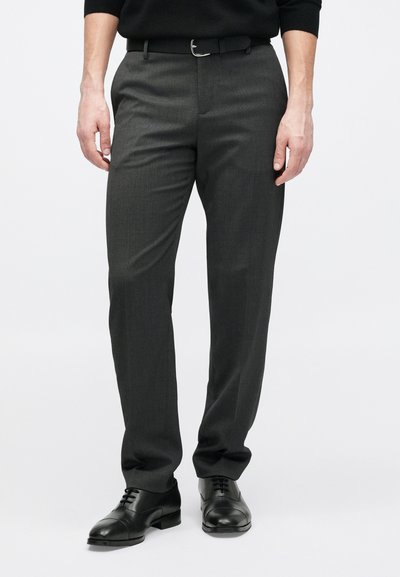 Gray dress pants made from a smooth, textured fabric. Tailored fit with a straight leg and flat front. Worn with black dress shoes.