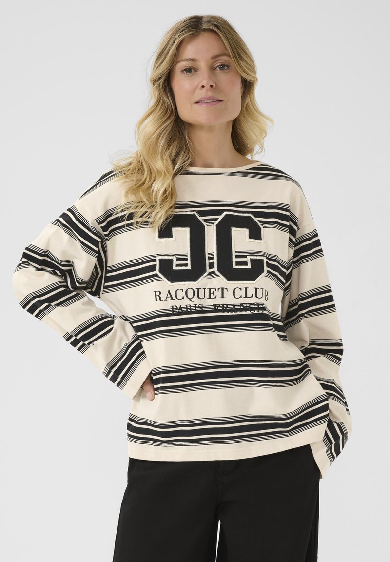 Felpa a maniche lunghe a righe beige e nere con il logo "JC" e il testo "RACQUET CLUB PARIS FRANCE", dal taglio morbido e dalla vestibilità ampia.