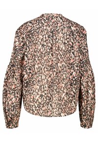 Blouse florale en tissu léger avec un motif à pois noir, rose et crème, présentant une coupe légèrement cropped et des manches longues bouffantes.