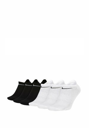 Five pairs of ankle socks, two black and three white, made of cotton blend, featuring a ribbed texture and a black Nike logo.