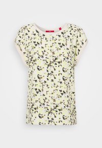 Short-sleeve, loose-fitting top in light yellow with a floral pattern in green, brown, and purple; round neckline with beige trim.