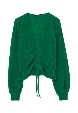 Pullover verde, con texture, scollatura a V, dettagli arricciati frontali e lacci per regolazione. Maniche lunghe e aderenti con polsini a costine.