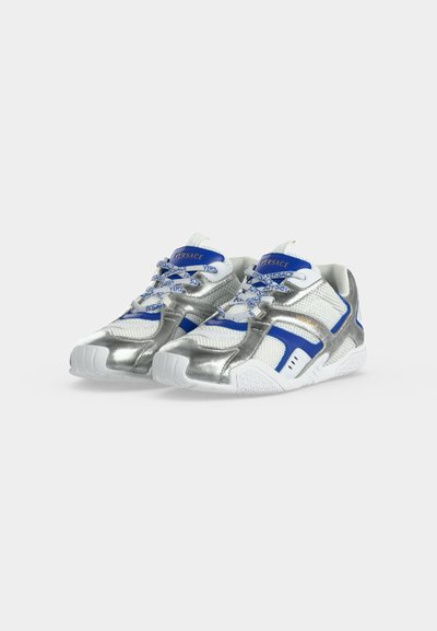 Paire de baskets Versace en mesh blanc avec des accents bleus et des superpositions métalliques argentées, avec des lacets et semelles brandés.