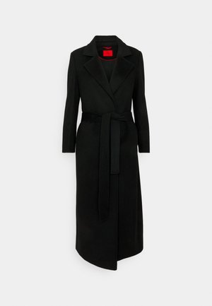 Black wool blend long coat with a notched collar, belted waist, and long sleeves. Features a red interior lining and a sleek silhouette.