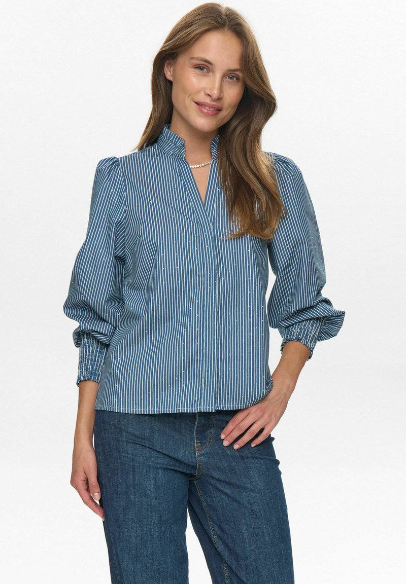Pruhovaná modrá blúzka s vysokým golierom, balónovými rukávmi a elastickými manžetami. Vyrobená z ľahkého materiálu, s výstrihom do V a voľným strihom.