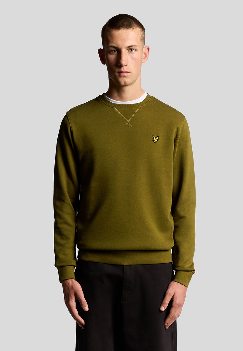 Felpa verde in cotone con polsini e orlo a costine, caratterizzata da un piccolo logo giallo sul petto. Design semplice, stile a girocollo.