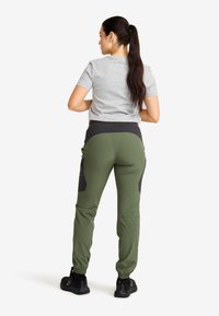 Gray short-sleeve t-shirt paired with olive green pants featuring black accents and pockets, tapered bottom, and elastic waistband.