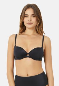 Black push-up bra with smooth, padded cups, adjustable straps, and a cut-out detail between the cups. Soft fabric with a sleek finish.