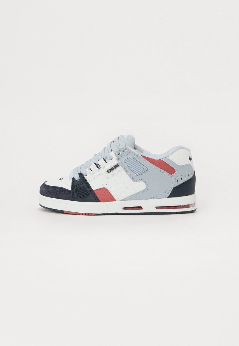 Sneaker with a white, light blue, and navy color scheme. Features suede and mesh materials, round laces, and a cushioned sole with red accents.