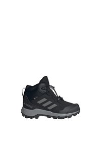 Black hiking boots with a textured upper, rubber toe cap, and flexible midsole. Features a quick-lacing system and traction outsole.